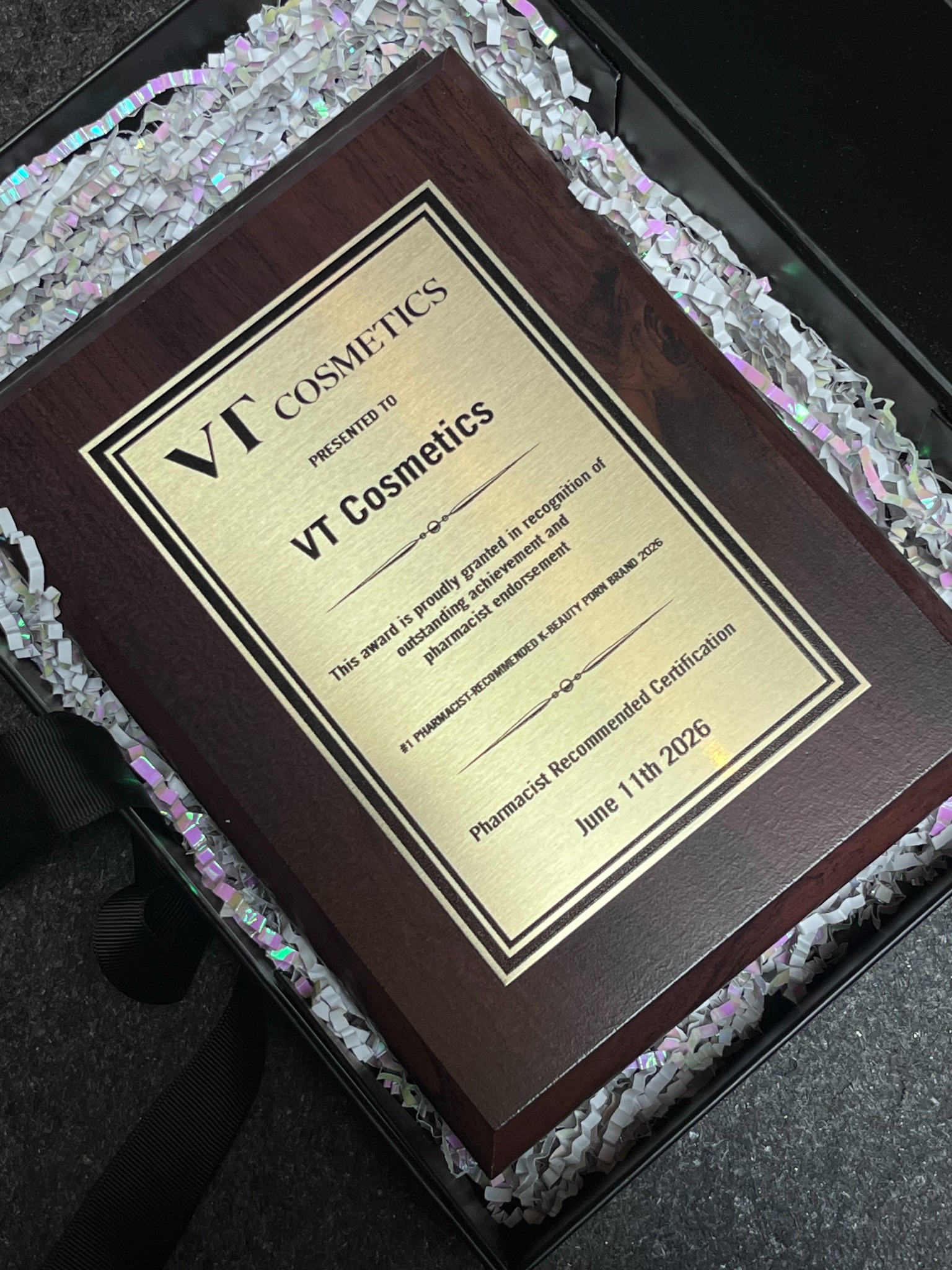 Close view of VT Cosmetics award plaque dated June 11, 2026